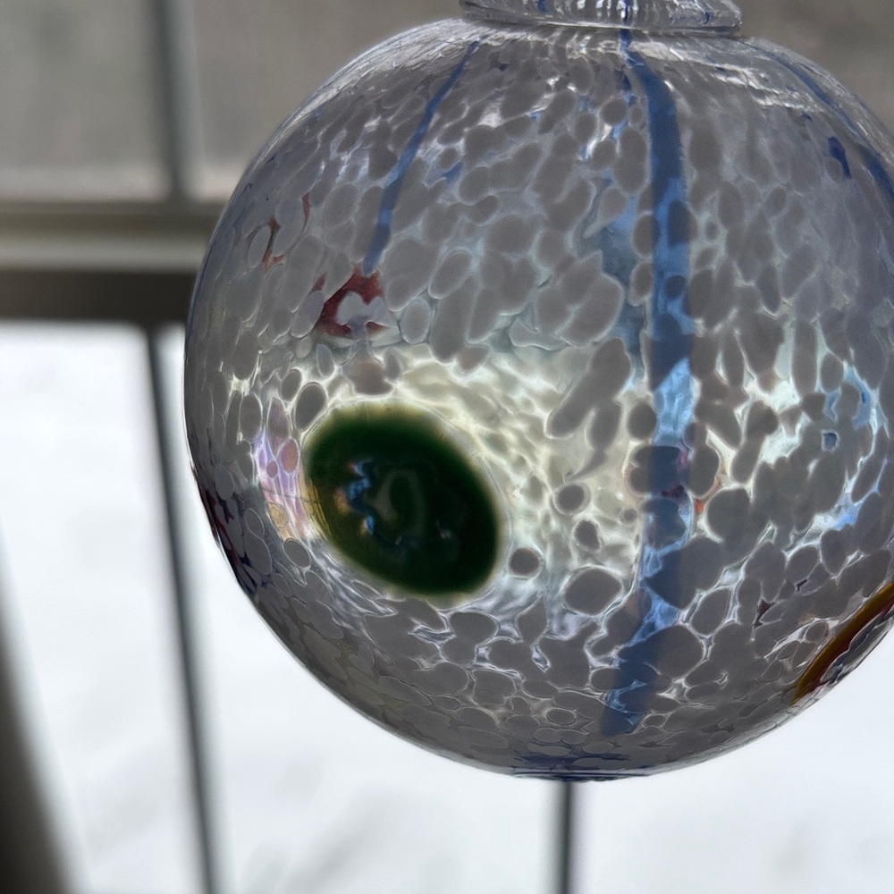 Handcrafted Blown Glass Ornament with Red and Blue Accents - Picture 3 of 4